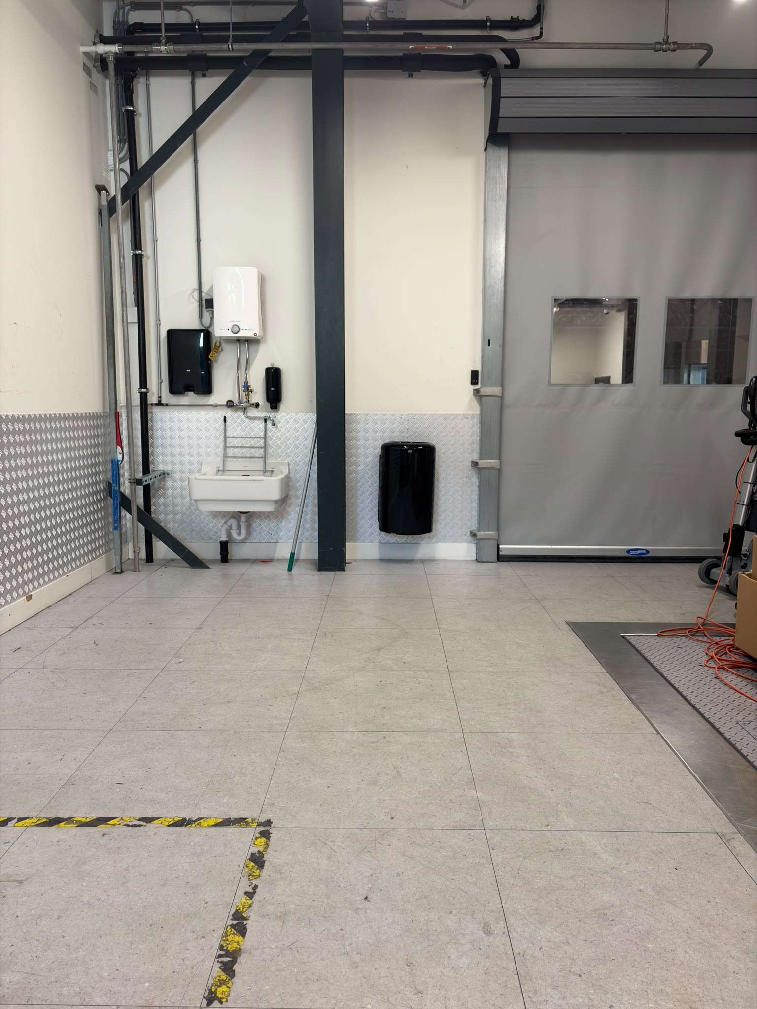 Worn, soiled ESD tile floor in a busy loading dock before RIFCO tile restoration